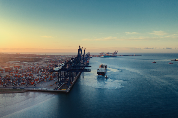 Sunrise of Felixstowe port as a container ship moves out to sea