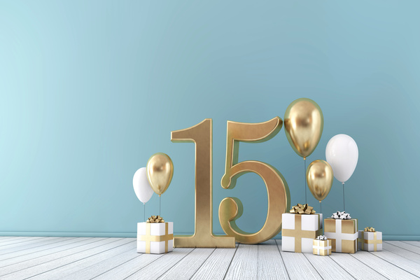 Number 15 party celebration. Blue background with a gold 15 and gold and white presents and balloons