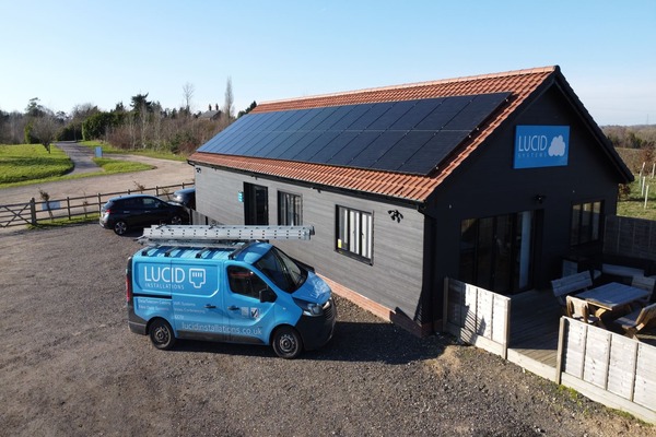 A photo of the roof of Lucid Systems in Ipswich along with solar panels. In front of the office building is a blue van marked up with the Lucid Systems logo
